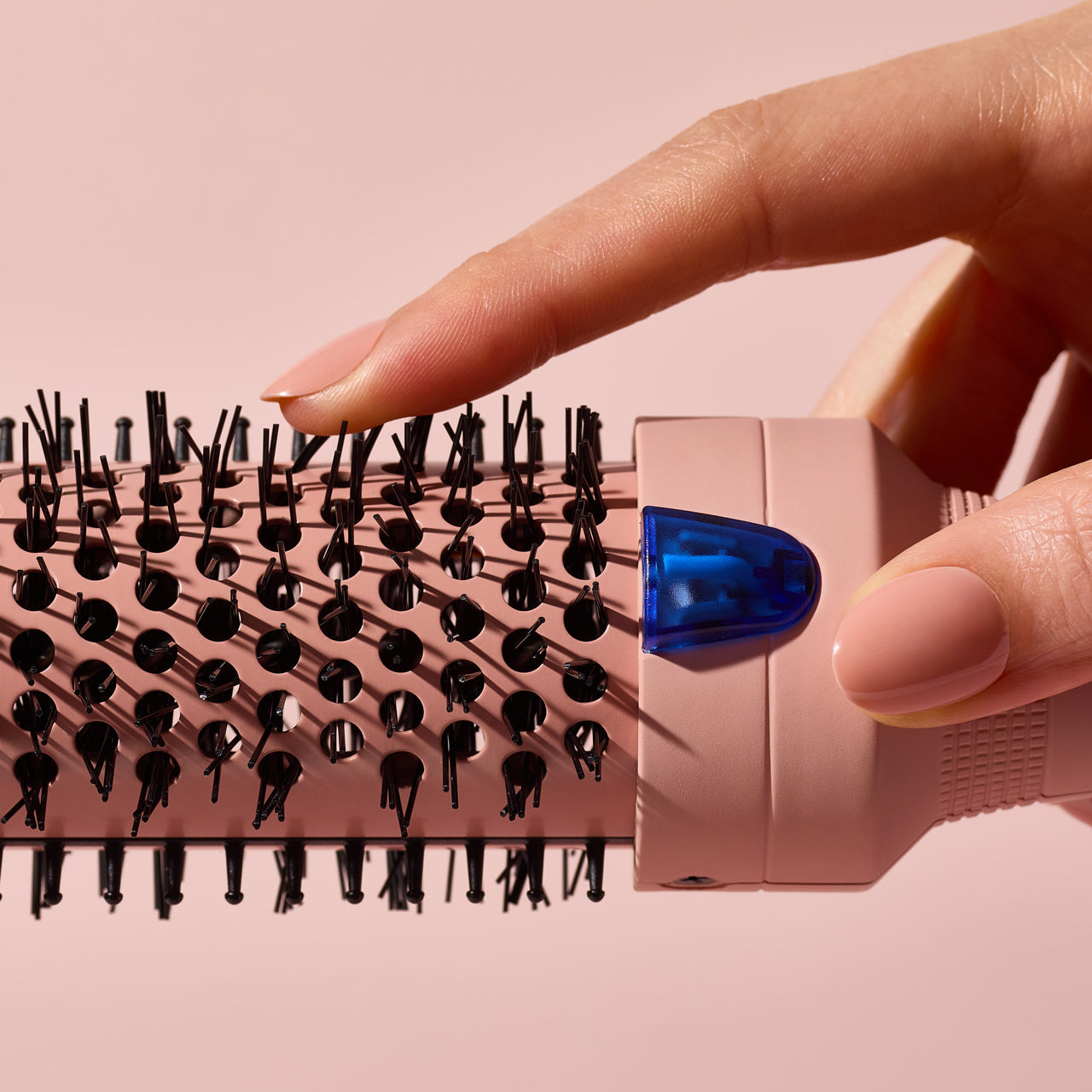 Model styling hair with Kitsch Terracotta Thermal Round Brush, showing volume and frizz-free finish