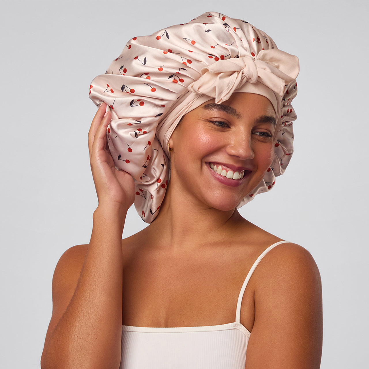 A model wearing kitsch oversized satin cherry printed bonnet